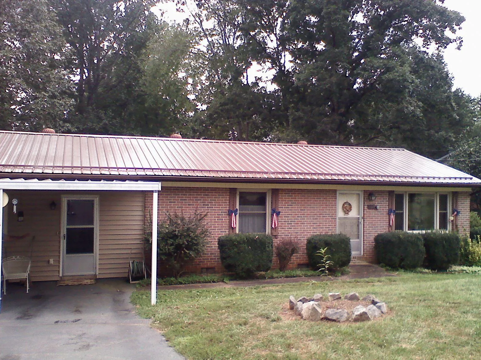 Bronze metal roof and carport on a brick ranch home in New Buffalo