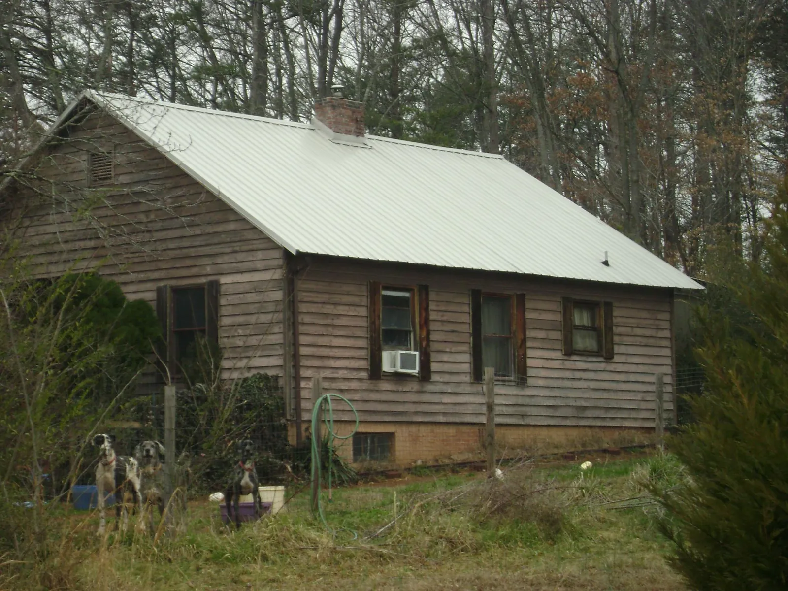 White metal roof on an old wood sided farmhouse, from a Metal Roof Installation job in New Buffalo